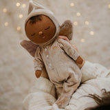 A child holding the pink Olli Ella Ada fairy dozy dinkum doll 