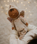 A child holding the pink Olli Ella Ada fairy dozy dinkum doll 