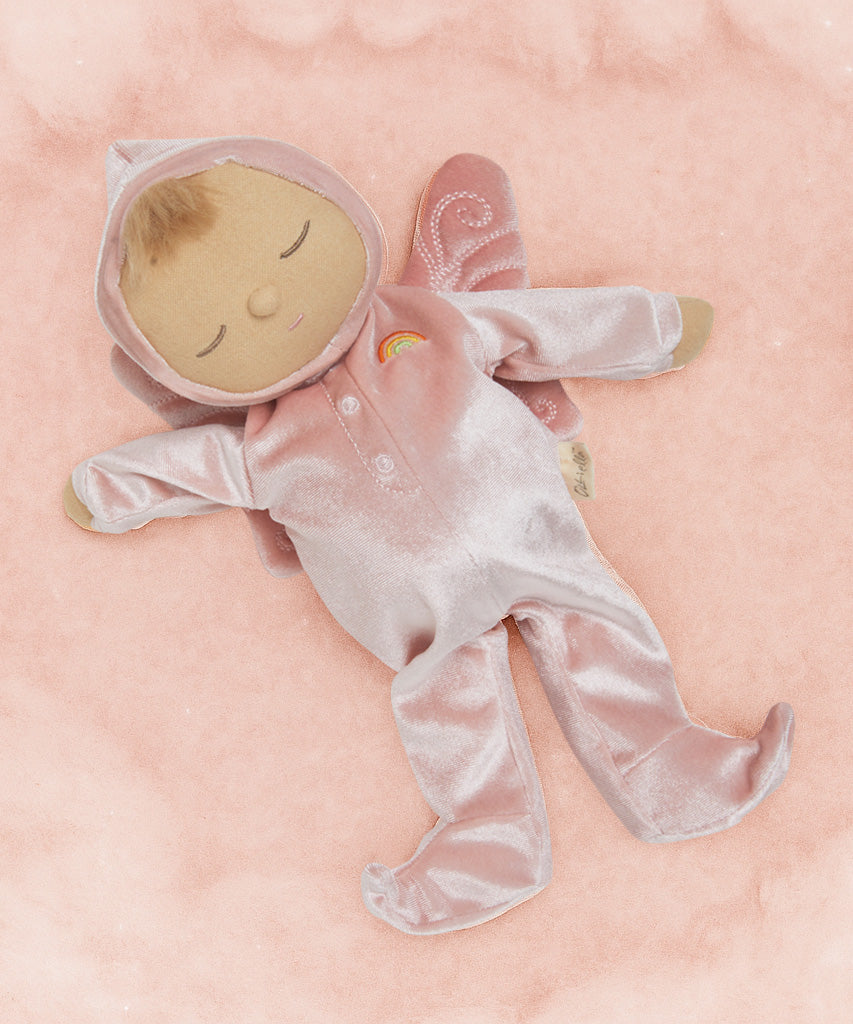 Olli Ella Aurora fairy dozy dinkum doll lying on a soft pink surface. 