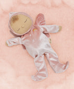 Olli Ella Aurora fairy dozy dinkum doll lying on a soft pink surface. 