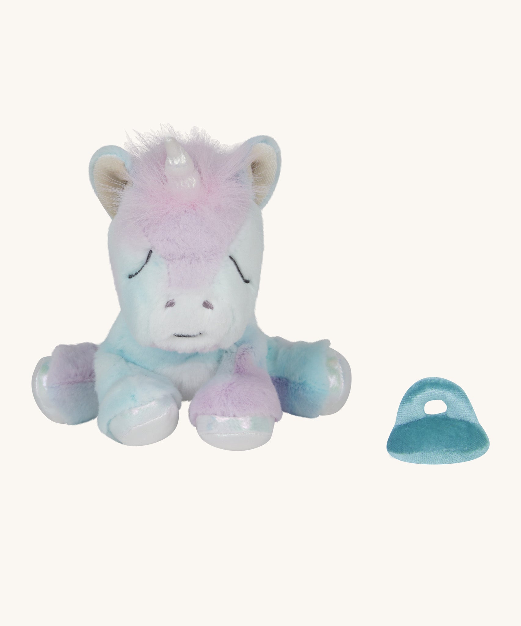 The Olli Ella baby binky unicorn dinkum. A soft and cuddly unicorn in light pastel colours. Features a white unicorn horn with a blue magnetic pacifier next to the leg