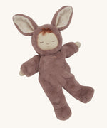 Olli Ella cozy dinkum bunny pickle doll in mauve colour posing. This is a soft and fluffy doll with a sleeping face, cute floppy ears and available at Babipur.