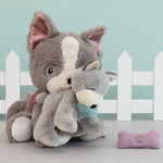 Gizmo the Olli Ella dinkum dog with a soft grey and white banjo the dinkum puppy in its mouth