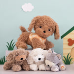 The grey, white and brown Olli Ella dinkum puppies with the Brown Olli Ella dog standing above them