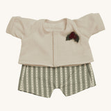 Olli Ella Dinkum Doll Holiday Outfit Set come with two adorable pieces, a set of dungarees with a green and cream patterned print, and a cream cardigan with a holly berry and leaf applique. The perfect outfit for any Dinkum Doll this Christmas! The image is on a cream background.