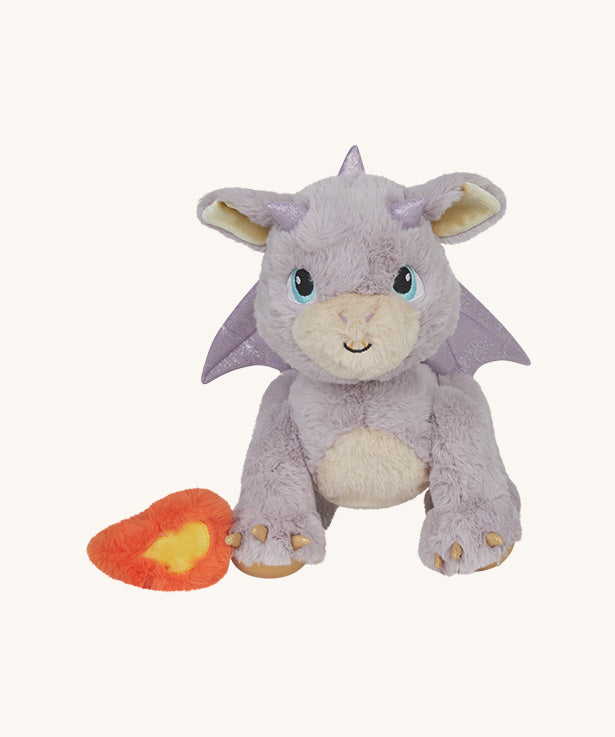 A light pink Olli Ella dinkum dragon blaze doll available at Babipur with the fluffy magnetic fire piece attached to the front paw. 