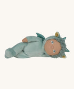 Olli Ella Dante the dragon dinky dinkum doll lying down. A pale green doll with matching curly hair and cute ears. 