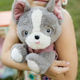 A child hugging the Olli Ella Gizmo dinkum dog. 