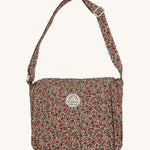 Olli Ella Carrie Convertible Changing Set - Garland. A beautiful floral print, cotton, changing bag for dolls and toys, with an adjustable shoulder strap. The changing bag coverts into a changing mat with the same floral print. The image is on a cream background