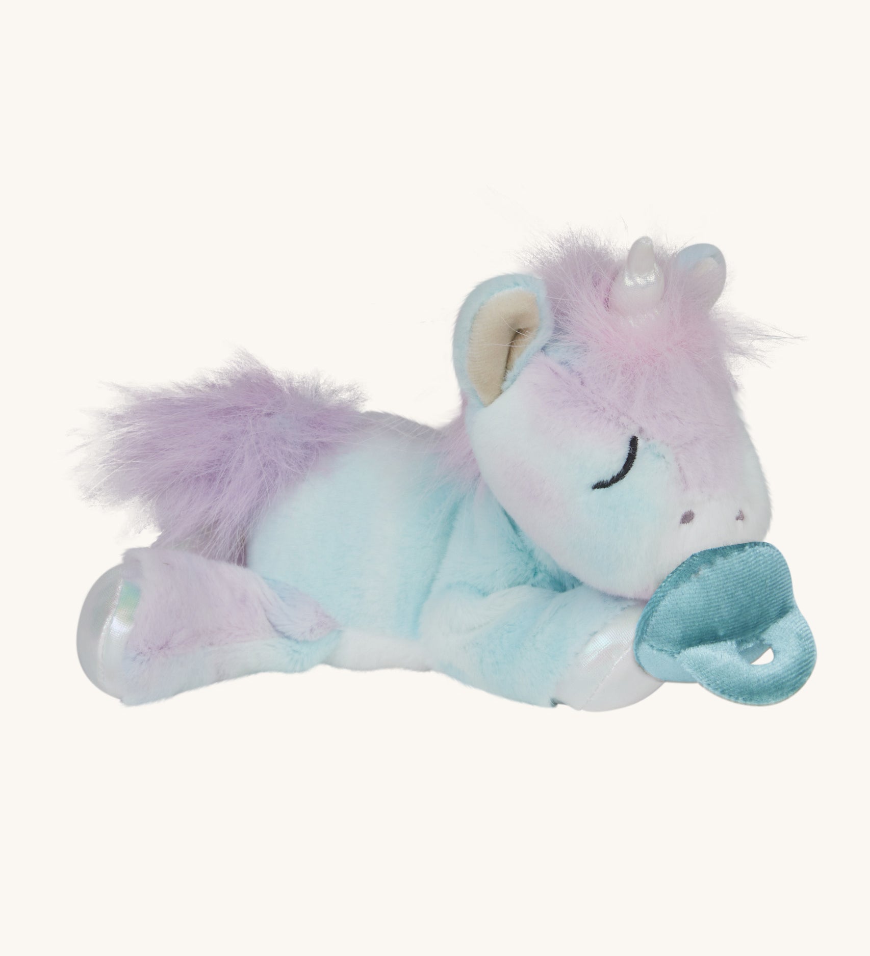 A posing Olli Ella baby binky unicorn dinkum. A soft and cuddly doll in light pastel colours. Features a white unicorn horn, light purple hair and a blue magnetic pacifier that can be put on the mouth