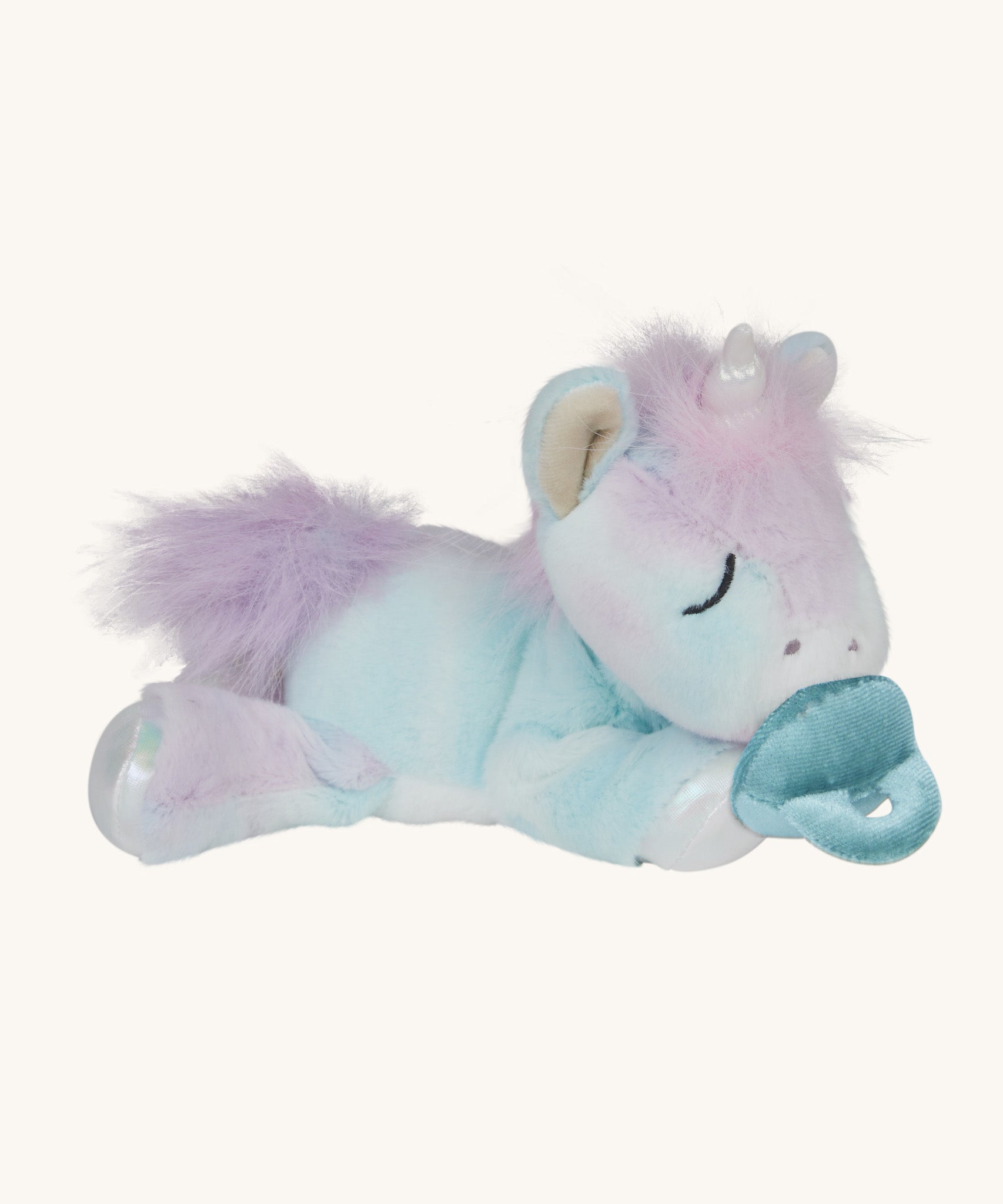 A posing Olli Ella baby binky unicorn dinkum. A soft and cuddly doll in light pastel colours. Features a white unicorn horn, light purple hair and a blue magnetic pacifier that can be put on the mouth
