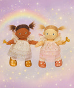 Olle Ella Willow and Freya dinkum dolls standing next to eachother against a dreamy rainbow background available at Babipur.