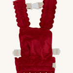 Olli Ella Dinkum Dolls Petal Carrier in Red Velvet, has scalloped petal shaped straps and waist band, adjustable straps and can be worn on the front and the back. The image is on a cream background