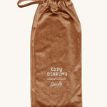 The soft, velvet textured bag that Olli Ella Cozy Dinkums - Teddy Twiggy come in, on a cream background.