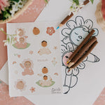 The stickers from the Olli Ella Limited Edition Blossom Buds Gift Set - Tulip, on a table with Olli Ella pencils and an Olli Ella Blossom Buds drawing