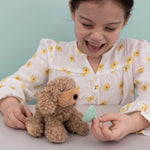 A child playing with the Olli Ella Benny the dinkum puppy