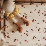 Avery Row Cotbed Fitted Sheet - Peachs on a bed with soft toys