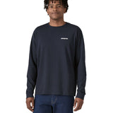 A person wearing the Patagonia L/S P-6 Logo Responsibili-Tee - New Navy, showing the fit from the front