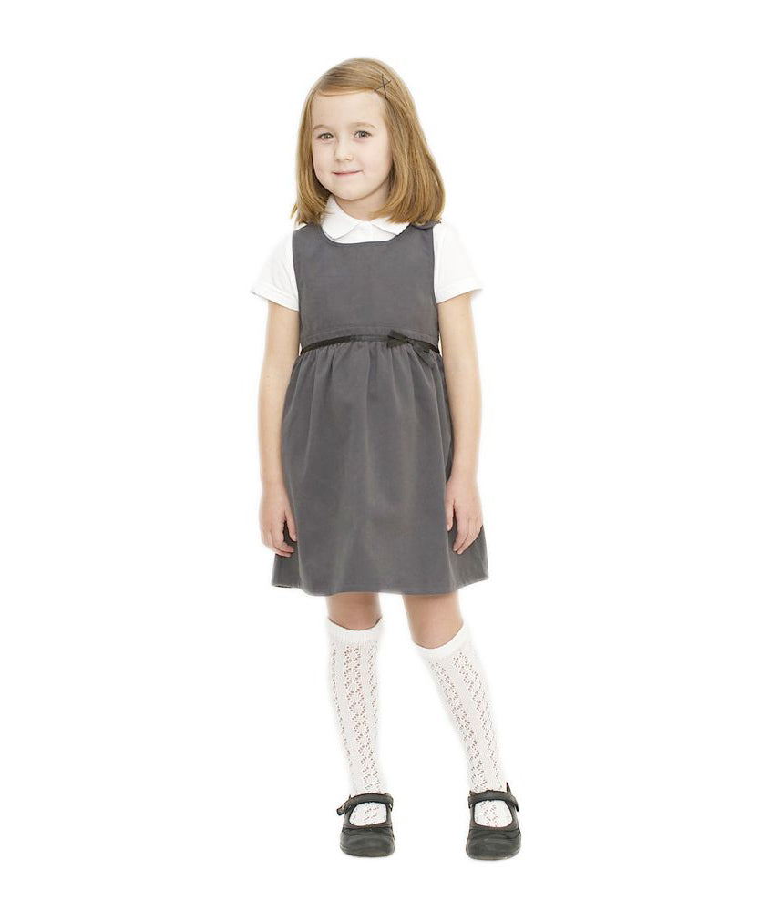 A little girl wearing the Eco Outfitters organic and fair trade cotton school pinafore dress in grey.