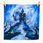 An organic play cloth with a fabulous spooky and Halloween print. A haunted manor on top of a steep hill side with stairs leading up to the door, has cute ghosts, bats and a witch circling around it. Behind the manor, is a large, full moon, and pumpkins outline the stairs and path to the manor