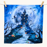 An organic play cloth with a fabulous spooky and Halloween print. A haunted manor on top of a steep hill side with stairs leading up to the door, has cute ghosts, bats and a witch circling around it. Behind the manor, is a large, full moon, and pumpkins outline the stairs and path to the manor