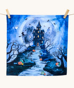 An organic play cloth with a fabulous spooky and Halloween print. A haunted manor on top of a steep hill side with stairs leading up to the door, has cute ghosts, bats and a witch circling around it. Behind the manor, is a large, full moon, and pumpkins outline the stairs and path to the manor