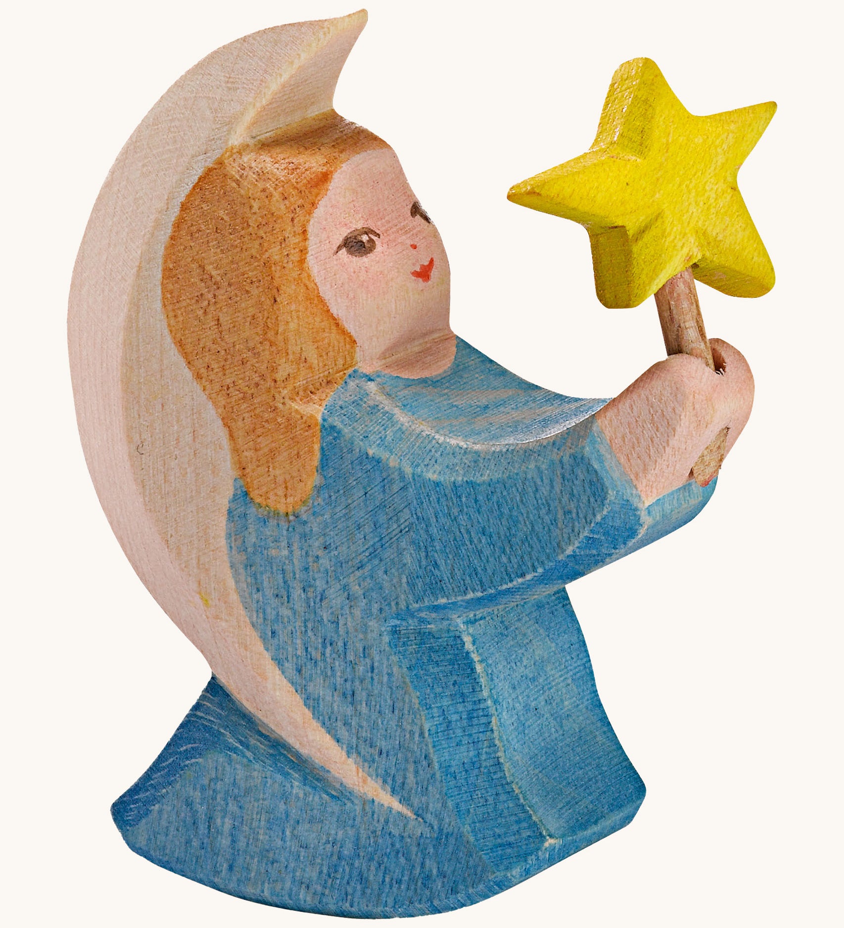 A Ostheimer wooden angel figure holding a star, available at Babipur. This handmade and hand painted festive figure has a blue dress and brown hair holding a yellow star