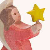 A close up of the Ostheimer wooden angel figure holding a star, available at Babipur showing the hand painted detail