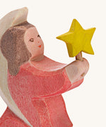A close up of the Ostheimer wooden angel figure holding a star, available at Babipur showing the hand painted detail