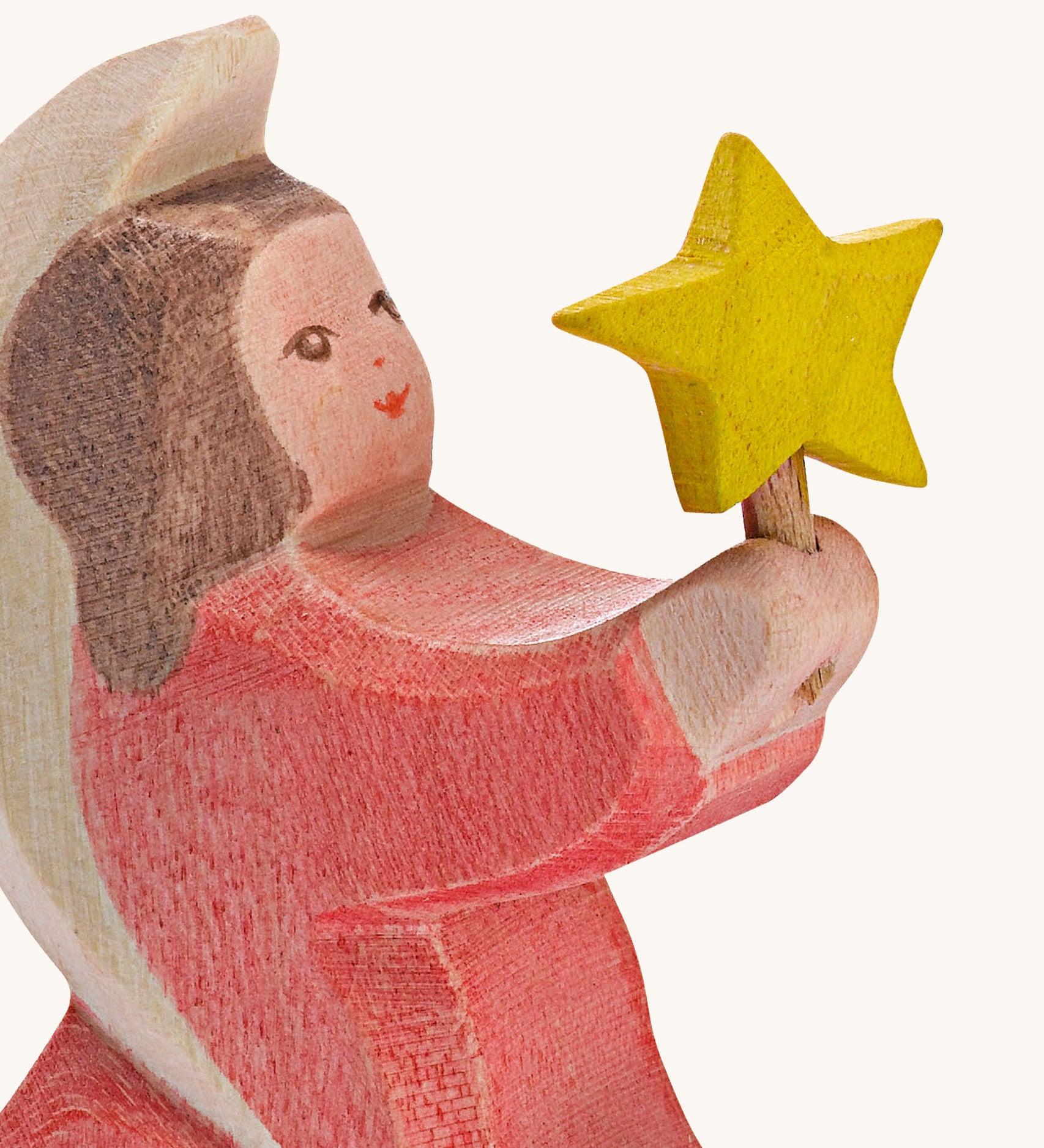 A close up of the Ostheimer wooden angel figure holding a star, available at Babipur showing the hand painted detail