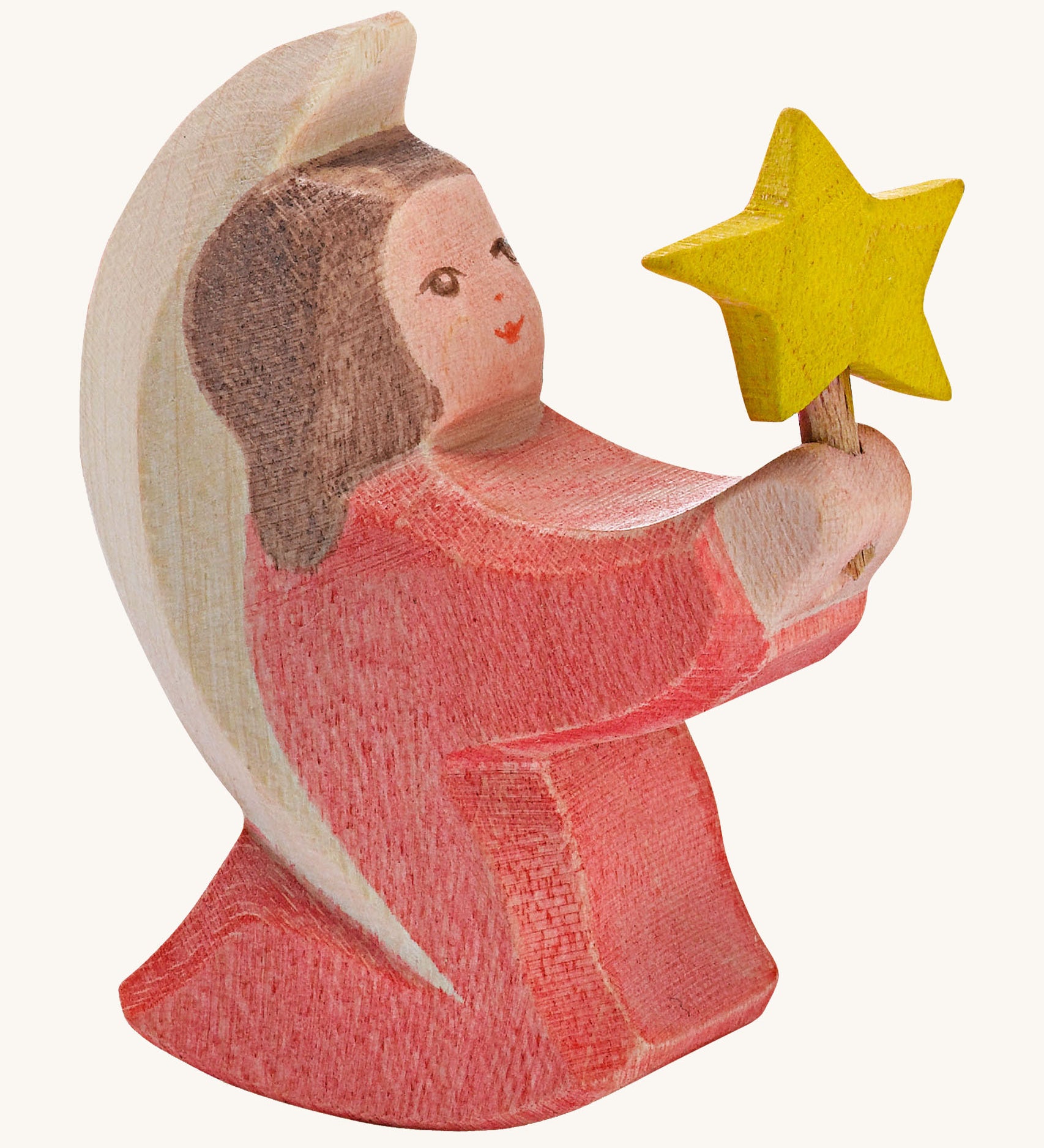 A Ostheimer wooden angel figure holding a star, available at Babipur. This handmade and hand painted festive figure has a rose pink dress and brown hair holding a yellow star