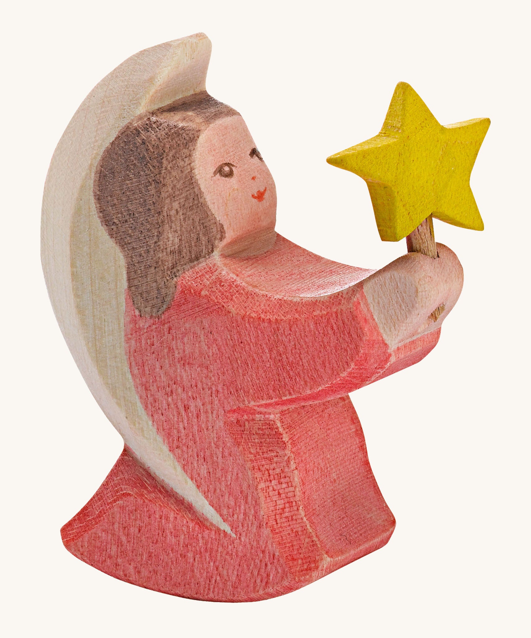 A Ostheimer wooden angel figure holding a star, available at Babipur. This handmade and hand painted festive figure has a rose pink dress and brown hair holding a yellow star