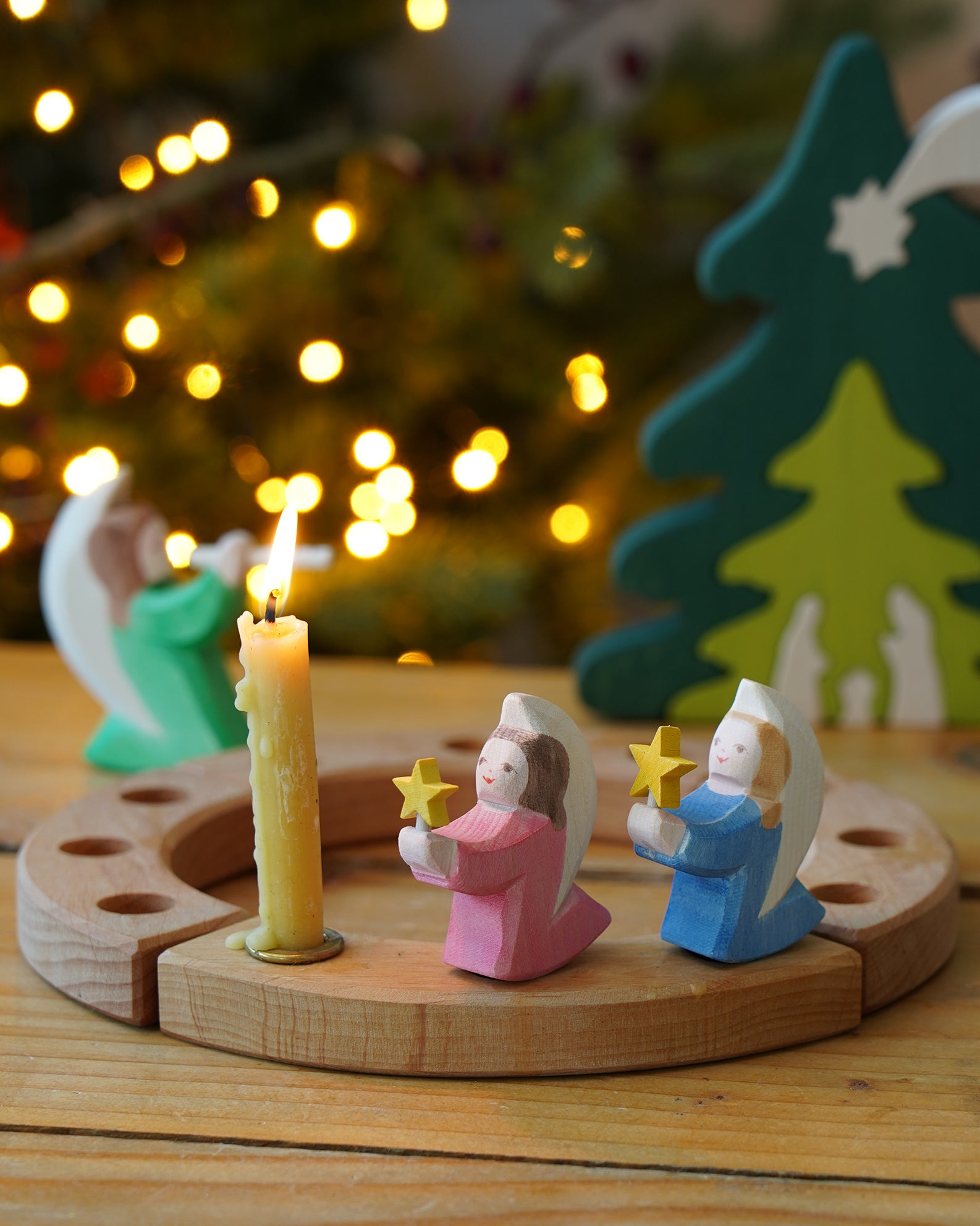 Pair of Ostheimer wooden angels with stars in blue and pink, for Christmas or nativity play or displays, on a Grimm's celebration ring, for sale at Babipur.