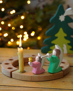 Grimm's Wooden Celebration Ring with Osthiemer Angels, pink with star and green with flute, Christmas rocking figures for sale at Babipur.
