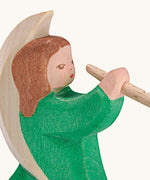 A close up of the Ostheimer wooden angel figure playing a flute, available at Babipur showing the hand painted detail