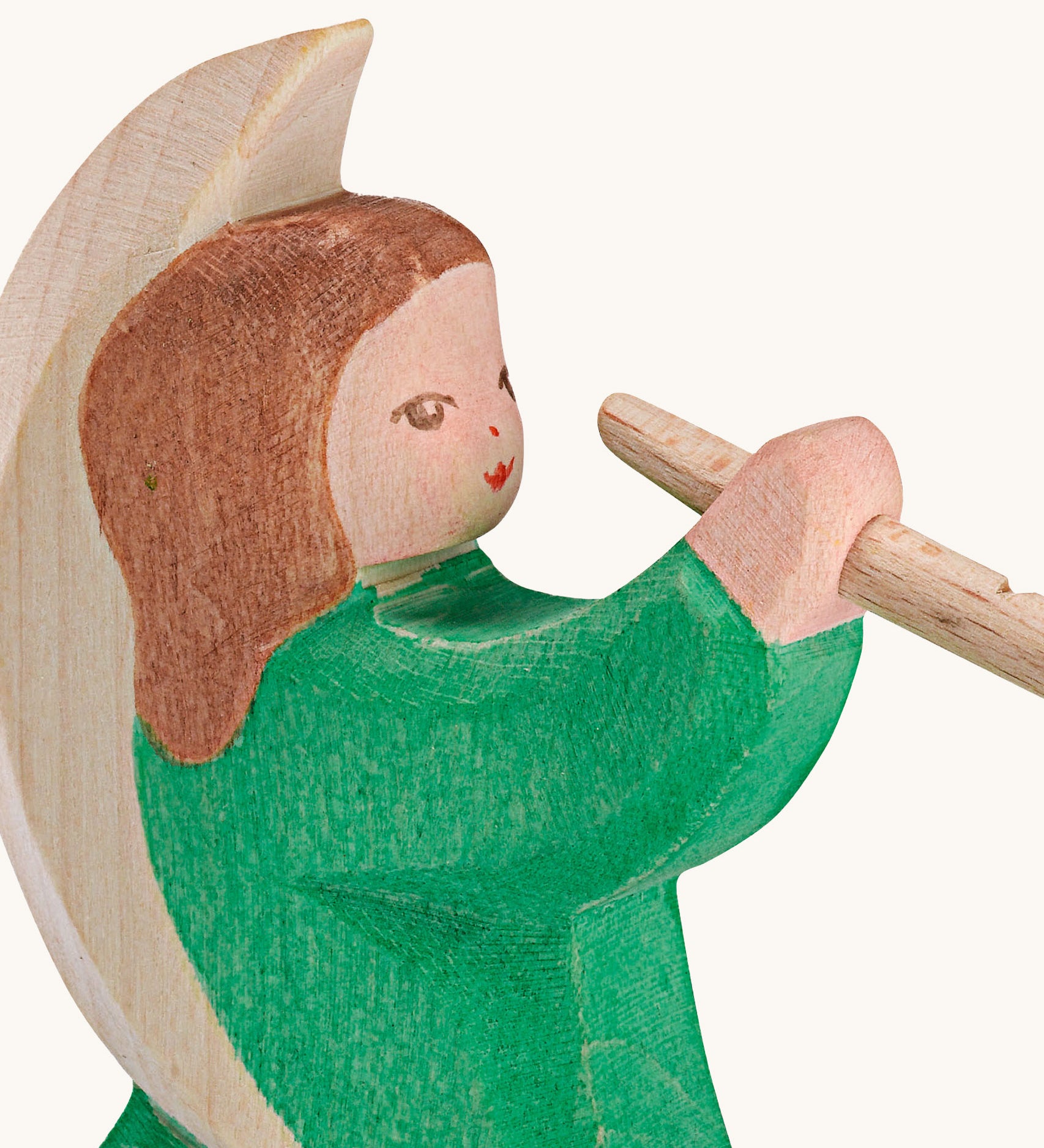A close up of the Ostheimer wooden angel figure playing a flute, available at Babipur showing the hand painted detail