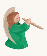 A Ostheimer wooden angel figure playing a flute, available at Babipur. This handmade and hand painted festive figure has a green dress and brown hair.