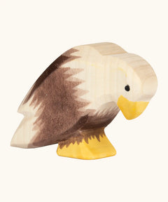 Ostheimer handcrafted wooden sitting bald eagle figure with hand painted brown body and unpainted head.