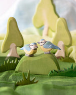 Ostheimer blue tits, wooden bird toys in small world play scene using Ostheimer trees, scarves and grass.