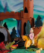The Ostheimer Wooden Toy Red Riding Knight fighting off an Ostheimer dragon, in a magical fairytale scene