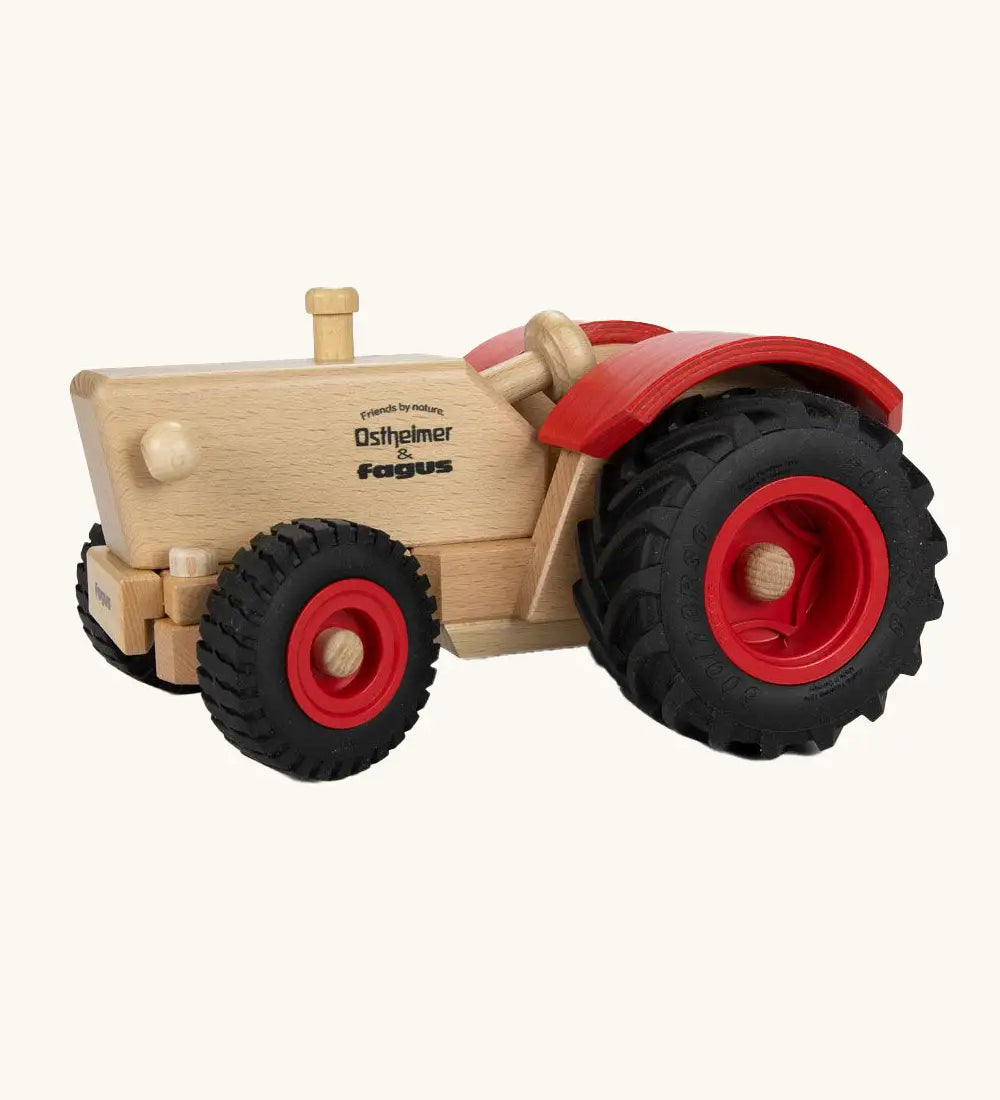 Ostheimer and Fagus collaboration handcrafted wooden traditional tractor with black wheels, red rims and mud guards