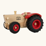 Ostheimer and Fagus collaboration handcrafted wooden traditional tractor with black wheels, red rims and mud guards