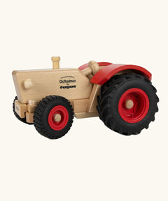 Ostheimer and Fagus collaboration handcrafted wooden traditional tractor with black wheels, red rims and mud guards