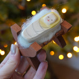Ostheimer wooden baby Jesus in crib figure - nativity toy or Christmas decoration - buy now at Babipur.
