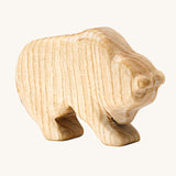 A beautiful, hand crafted bear figure showing the natural wood of the toy