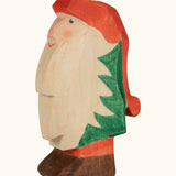 Ostheimer hand crafted Norbet winter gnome figure with hand painted green outfit red hat and unpainted beard