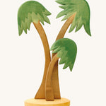 3 Ostheimer Palm Trees with a base support, with green leaves and light brown tree trunks. Set a nativity scene for Advent and Christmas or make your very own desert island with this group of three towering palm trees, swaying gently in the breeze