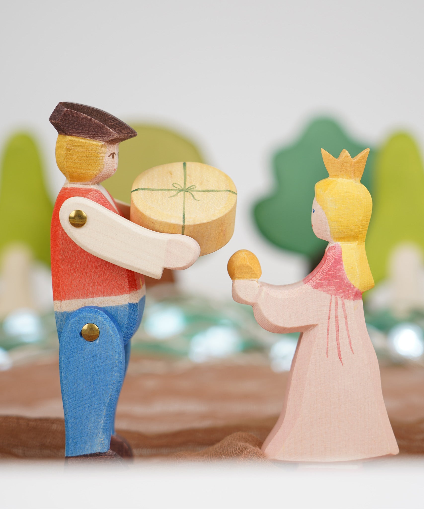 Ostheimer Rider and Princess wooden toy figures, handmade in Germany, exchanging a small round round, Waldorf and small world play scene, sold at Babipur