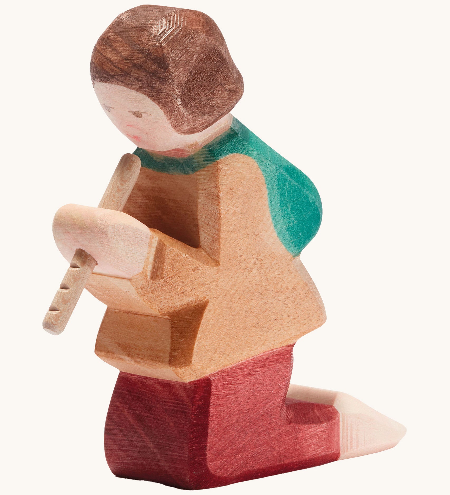A Ostheimer wooden shepherd figure playing the flute available at Babipur. This handmade and hand painted kneeling figure has a brown top, red trousers and holding a flute