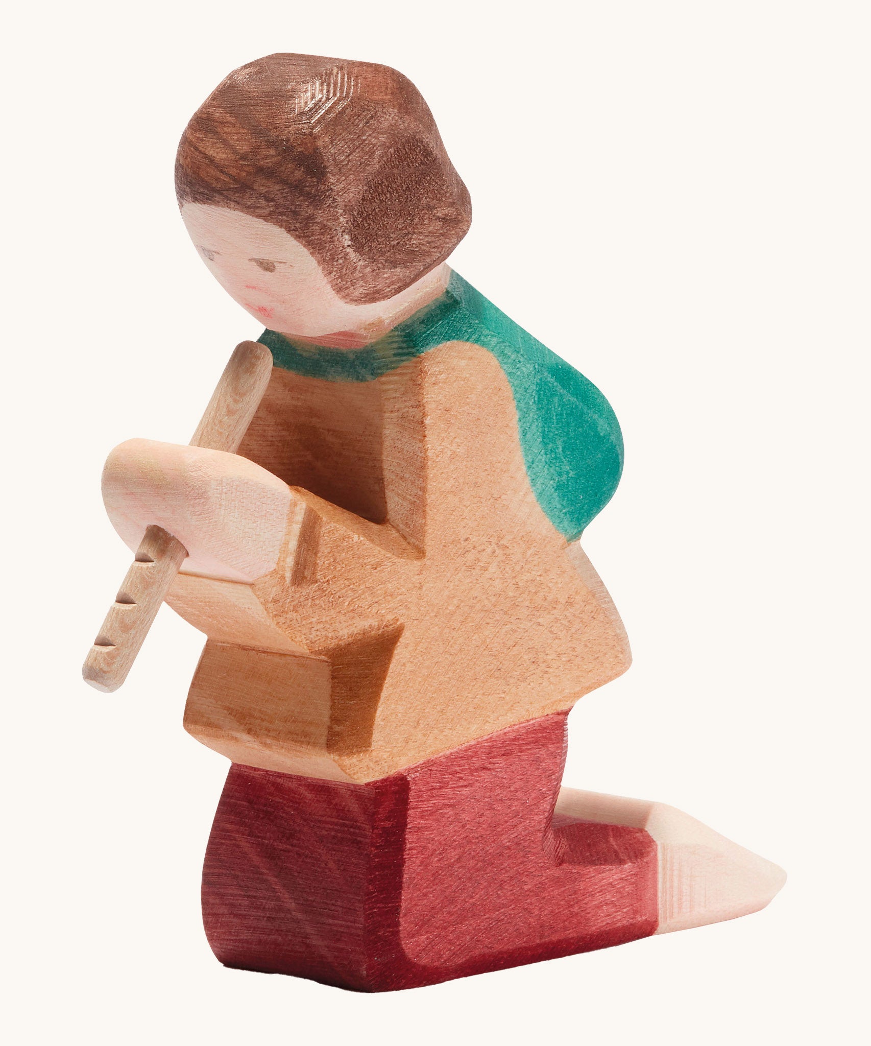 A Ostheimer wooden shepherd figure playing the flute available at Babipur. This handmade and hand painted kneeling figure has a brown top, red trousers and holding a flute